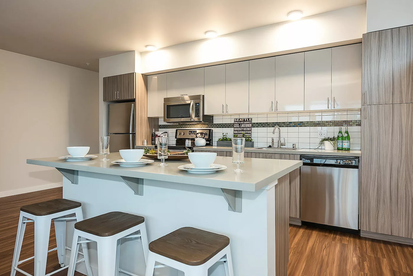 Kitchen with island seating and stainless steel appliances in an apartment home at The Fifteen in North Capitol Hill, Seattle